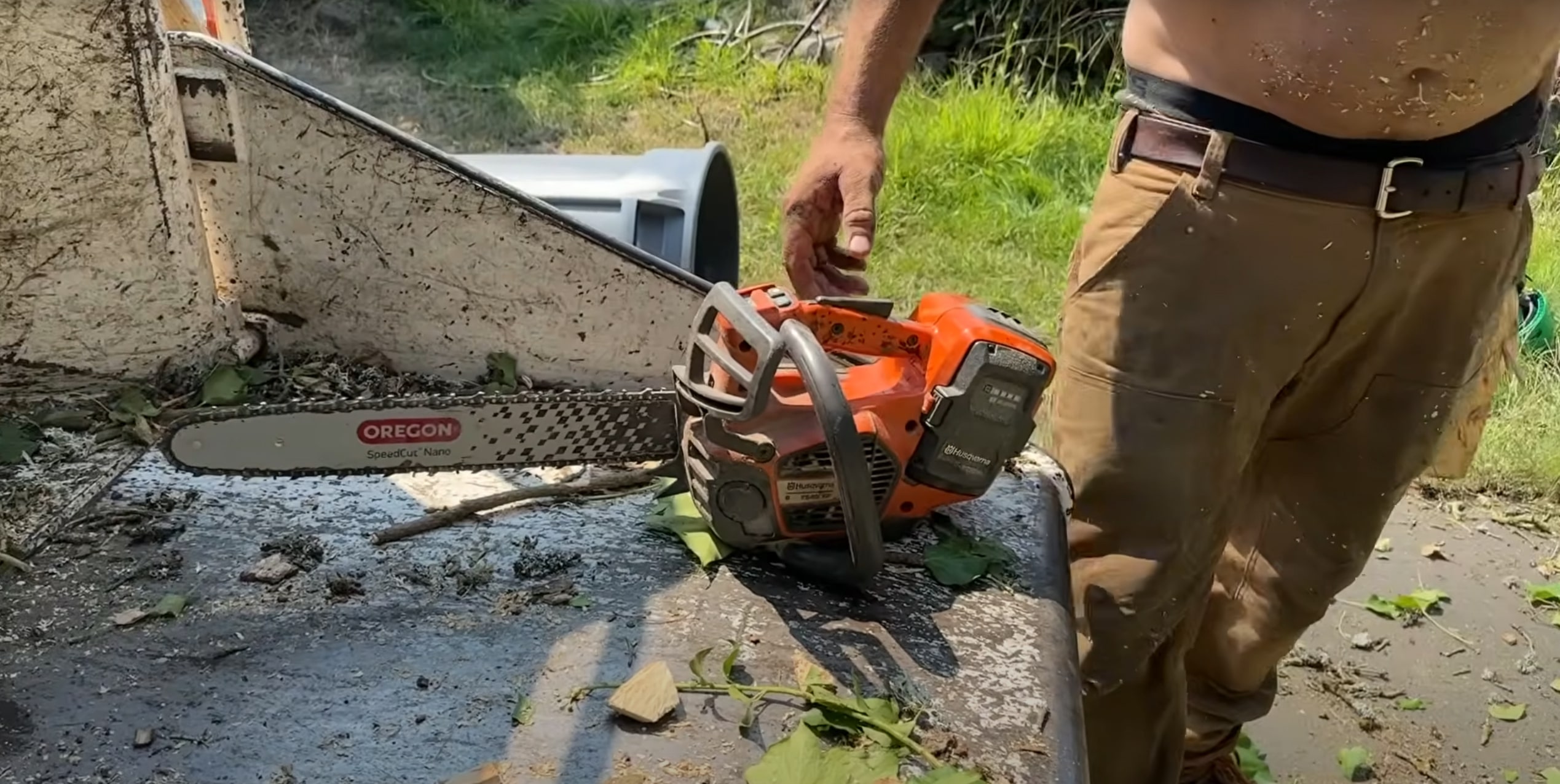 Professional arborist using chainsaw with proper safety equipment for seasonal tree trimming in Compton, CA